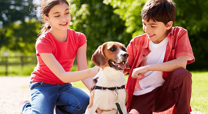 Kids petting their pet dog